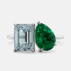 Toi et Moi ring with an emerald-cut Sky Blue Topaz and a pear-cut Emerald.