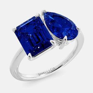 Toi et Moi ring with an emerald-cut Blue Sapphire and a pear-cut Blue Sapphire.