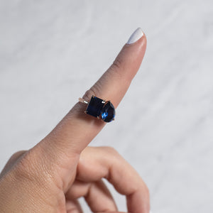 Toi et Moi ring with an emerald-cut Blue Sapphire and a pear-cut Blue Sapphire.