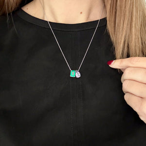 Toi et Moi necklace with an emerald-cut Emerald and a pear-cut gemstone.