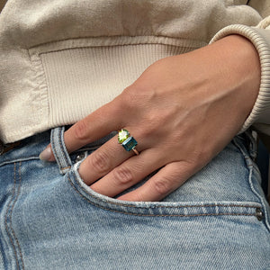 Toi et Moi ring with an emerald-cut London Blue Topaz and a pear-cut Green Peridot.