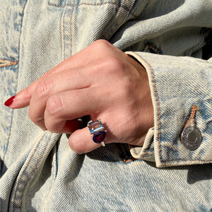Toi et Moi ring with an emerald-cut Aquamarine and a pear-cut Garnet.