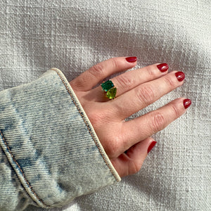 Toi et Moi ring with an emerald-cut Emerald and a pear-cut Green Peridot.