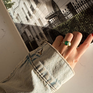 Toi et Moi ring with an emerald-cut Emerald and a pear-cut Green Peridot.