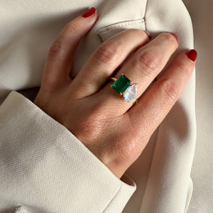 Toi et Moi ring with an emerald-cut Emerald and a pear-cut Moonstone.