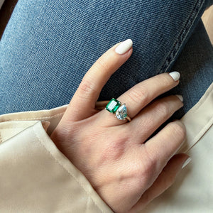 Toi et Moi ring with an emerald-cut Emerald and a pear-cut Aquamarine.