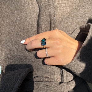Toi et Moi ring with an emerald-cut London Blue Topaz and a pear-cut London Blue Topaz.