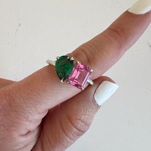 Toi et Moi ring with an emerald-cut Pink Sapphire and a pear-cut Emerald.
