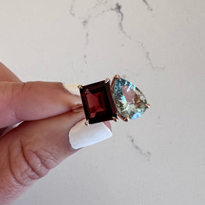 Toi et Moi ring with an emerald-cut Garnet and a pear-cut Aquamarine.