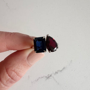 Toi et Moi ring with an emerald-cut Blue Sapphire and a pear-cut Garnet.