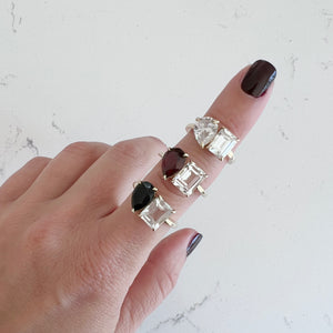 Toi et Moi ring with an emerald-cut Diamond and a pear-cut Blue Sapphire.