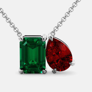 Toi et Moi necklace with an emerald-cut Emerald and a pear-cut gemstone.