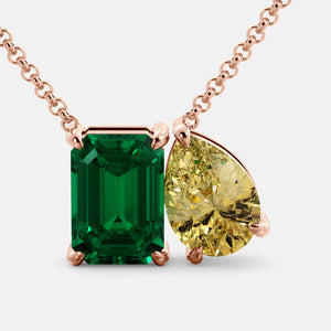 Toi et Moi necklace with an emerald-cut Emerald and a pear-cut gemstone.