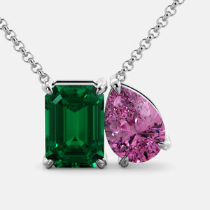 Toi et Moi necklace with an emerald-cut Emerald and a pear-cut gemstone.