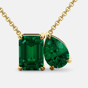 Toi et Moi necklace with an emerald-cut Emerald and a pear-cut gemstone.