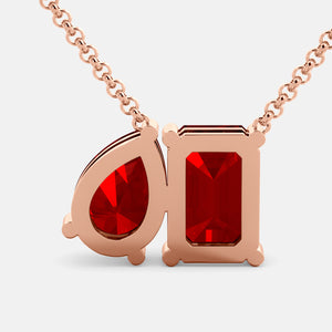 Toi et Moi necklace with an emerald-cut Ruby and a pear-cut gemstone.