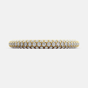 A close-up of a 3-row lab-grown diamond wedding band in 14K yellow gold. The band is set with round brilliant diamonds that sparkle and shine. The band is a beautiful and timeless choice for a wedding band.