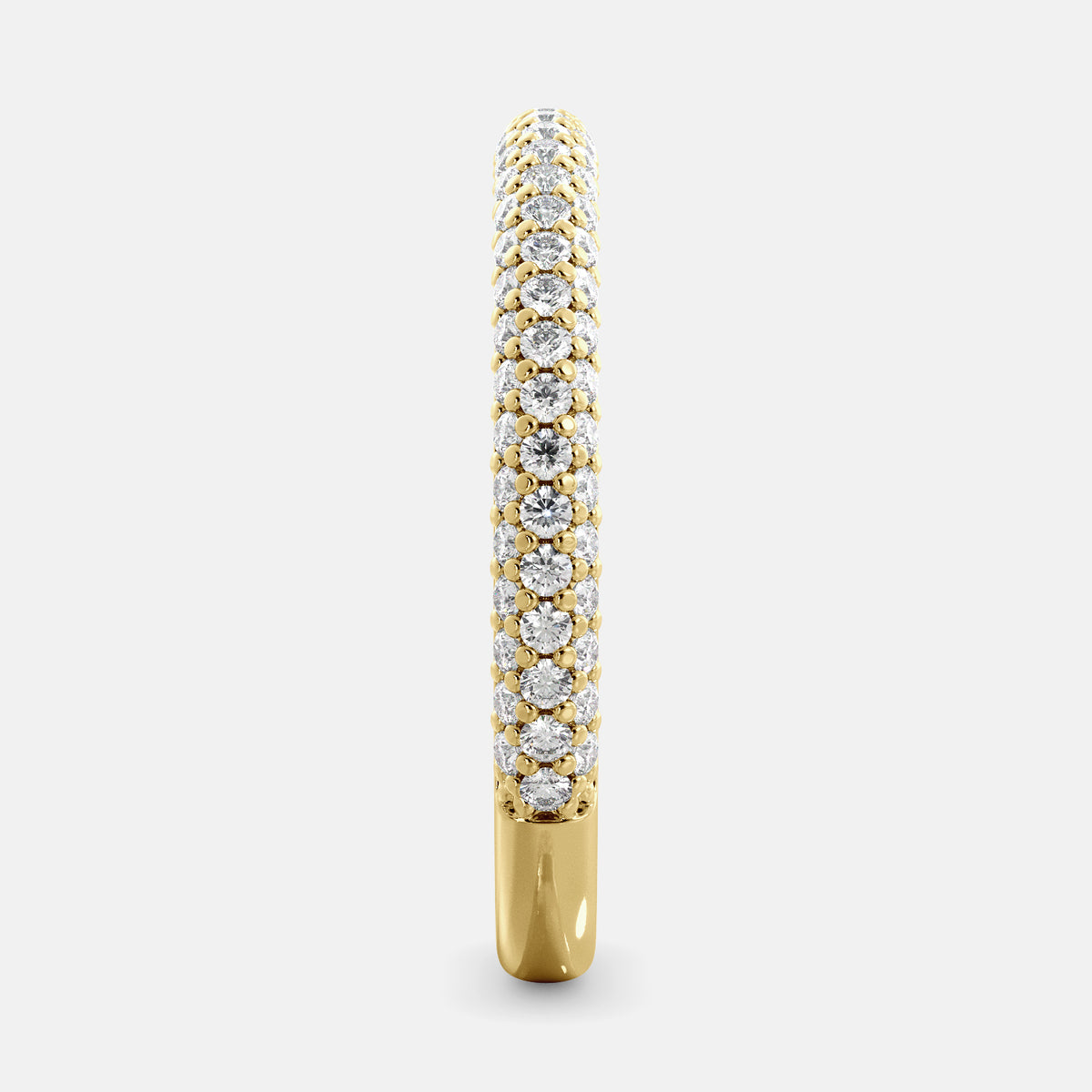 A close-up of a 3-row lab-grown diamond wedding band in 14K yellow gold. The band is set with round brilliant diamonds that sparkle and shine. The band is a beautiful and timeless choice for a wedding band.