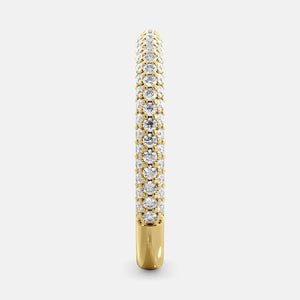 A close-up of a 3-row lab-grown diamond wedding band in 14K yellow gold. The band is set with round brilliant diamonds that sparkle and shine. The band is a beautiful and timeless choice for a wedding band.