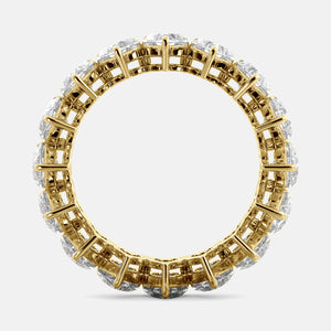 A close-up of a heart-shaped lab-grown diamond eternity wedding band in 14K yellow gold. The band is set with heart shape brilliant diamonds that sparkle and shine. The band is a beautiful and unique choice for a wedding band.