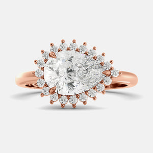 Rose gold ring with a large diamond and smaller diamonds on a light gray background