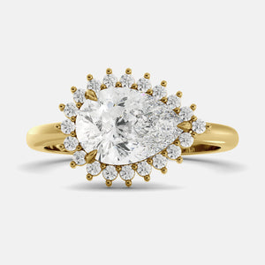 pear cut diamond ring in a halo setting on a white background
