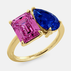 Toi et Moi ring with an emerald-cut Pink Sapphire and a pear-cut Blue Sapphire.