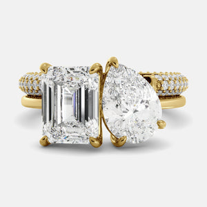 Gold ring with two large diamonds on a white background