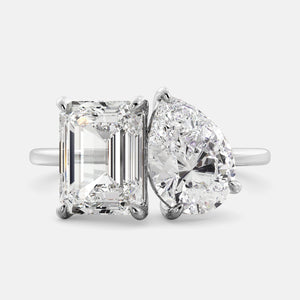 Toi et Moi ring with an emerald-cut Diamond and a pear-cut Diamond.