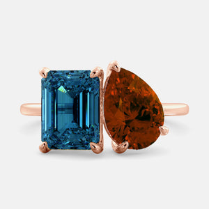 Toi et Moi ring with an emerald-cut London Blue Topaz and a pear-cut Garnet.