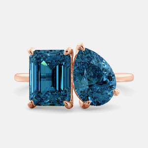 Toi et Moi ring with an emerald-cut London Blue Topaz and a pear-cut London Blue Topaz.
