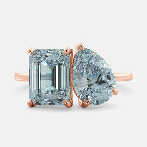 Toi et Moi ring with an emerald-cut Sky Blue Topaz and a pear-cut Aquamarine.