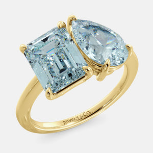 Toi et Moi ring with an emerald-cut Sky Blue Topaz and a pear-cut Aquamarine.