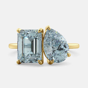 Toi et Moi ring with an emerald-cut Sky Blue Topaz and a pear-cut Aquamarine.