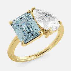 Toi et Moi ring with an emerald-cut Sky Blue Topaz and a pear-cut Diamond.