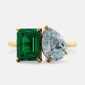 Toi et Moi ring with an emerald-cut Emerald and a pear-cut Aquamarine.