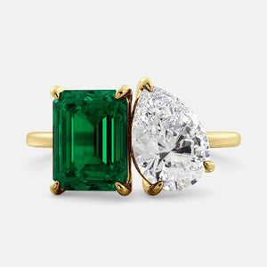 Toi et Moi ring with an emerald-cut Emerald and a pear-cut Diamond.