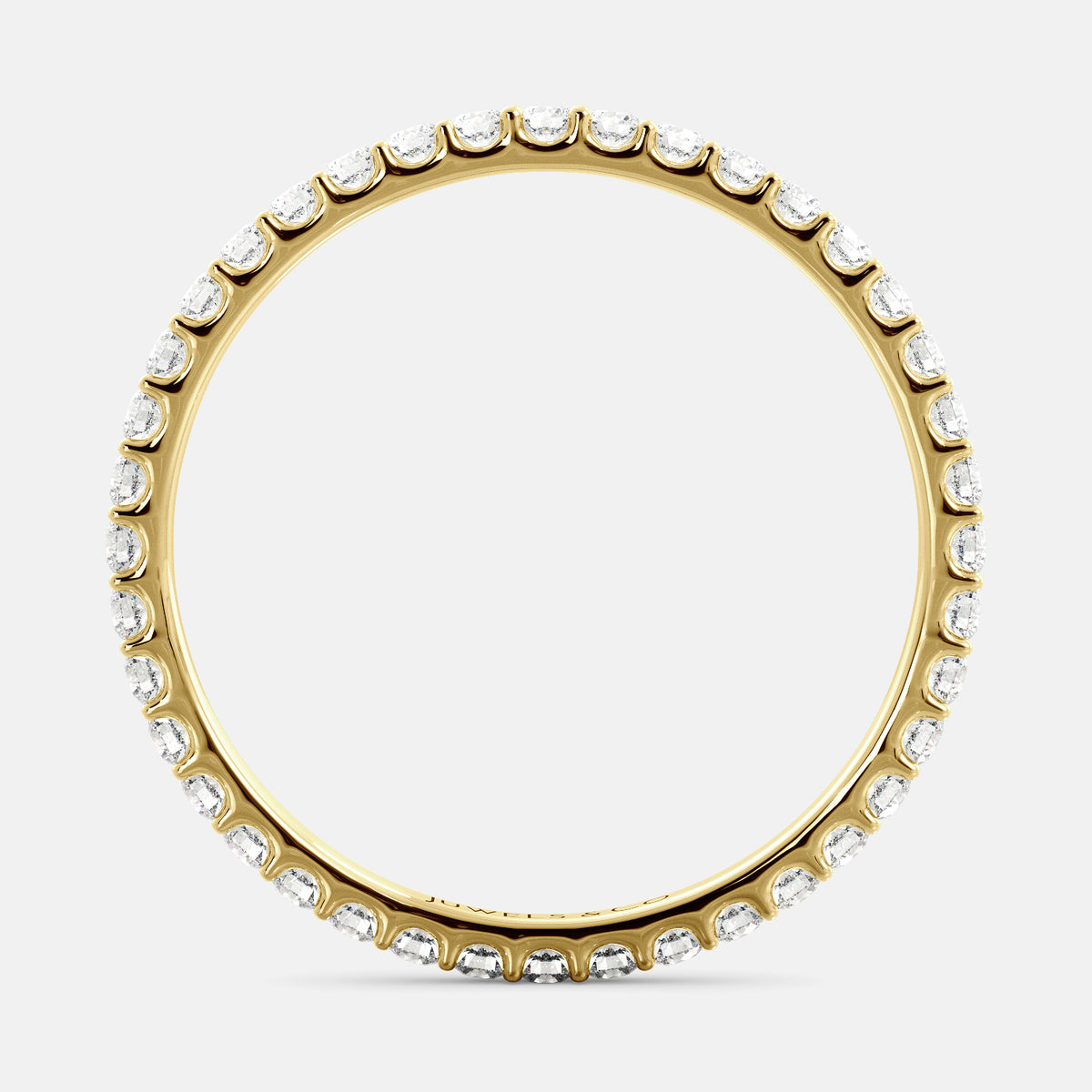 A close-up of a yellow gold eternity wedding band with a row of round diamonds. The band is a classic and timeless design that is perfect for any occasion. The diamonds sparkle and shine, adding a touch of glamour. The band is made of 14K yellow gold and features lab-grown diamonds that are conflict-free.