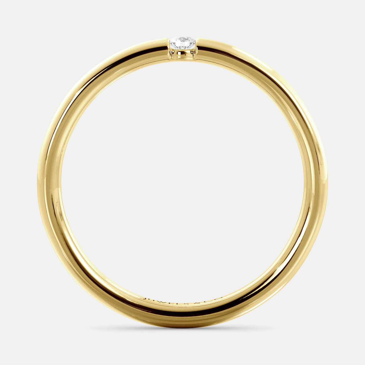 A close-up of a simple round wedding band in 14K yellow gold with a small round diamond in the center. The band is a classic and timeless design that is perfect for any occasion. The diamond is a beautiful accent that adds a touch of glamour.