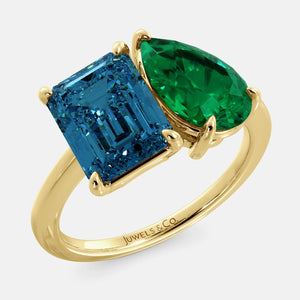 Toi et Moi ring with an emerald-cut London Blue Topaz and a pear-cut Emerald.