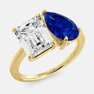 Toi et Moi ring with an emerald-cut Diamond and a pear-cut Blue Sapphire.