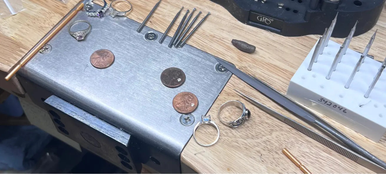jewelry work bench with several different ring designs showing
