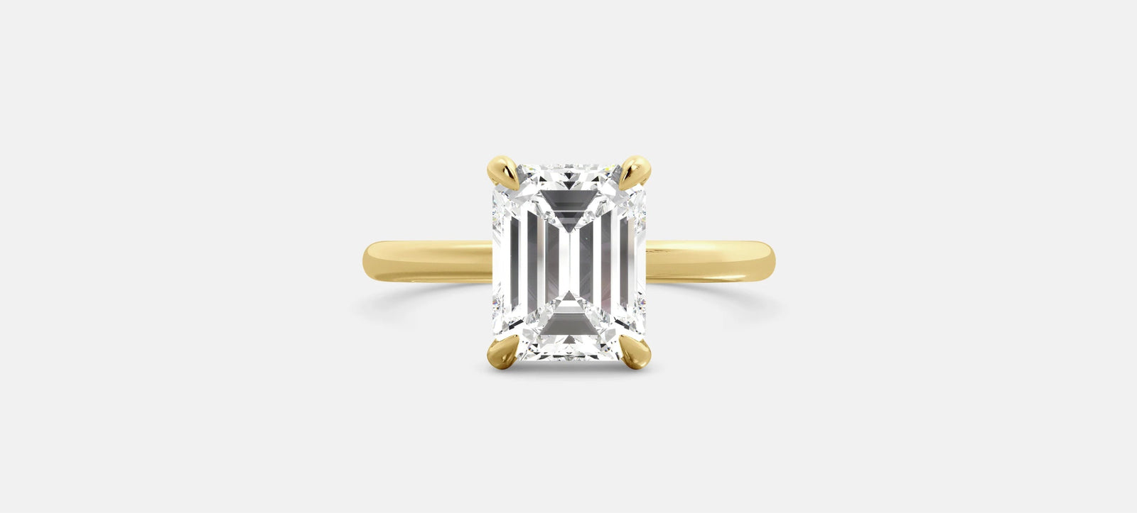 Emerald cut Diamond solitaire ring on a grey background