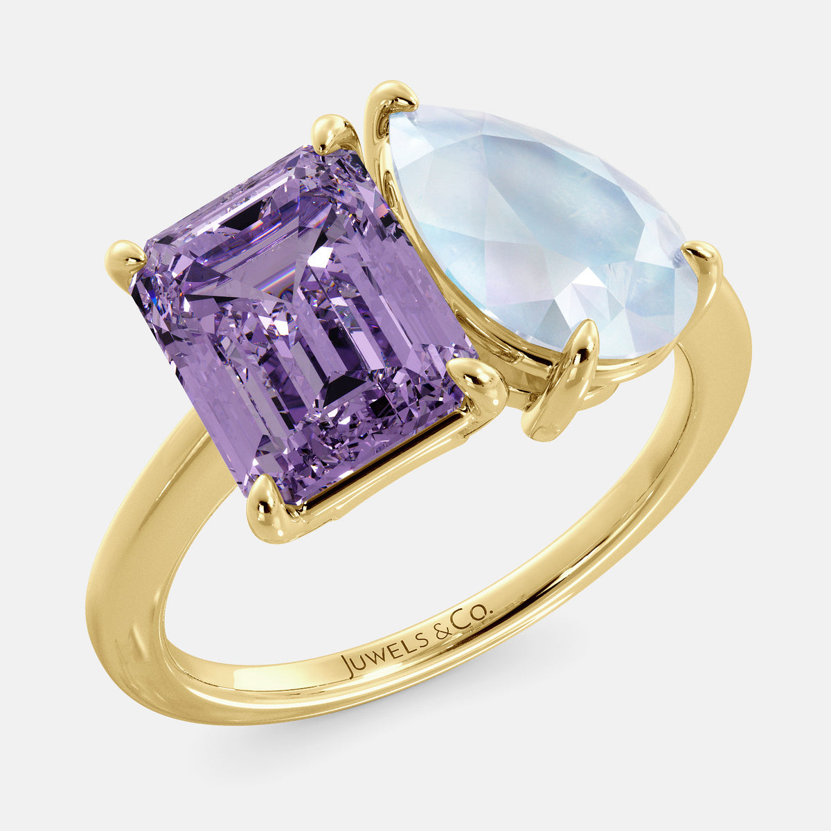A toi et moi ring with an emerald-cut amethyst and a pear-cut gemstone. The emerald-cut is set on the left of the ring, and the pear-cut gemstone is set on the right. The ring is made of recycled yellow gold and has a simple, elegant design. The pear-cut gemstone can be customized. **Here are some additional details about the image:** * The emerald-cut amethyst is a birthstone for February. * The pear-cut gemstone can be customized to any stone of your choice.