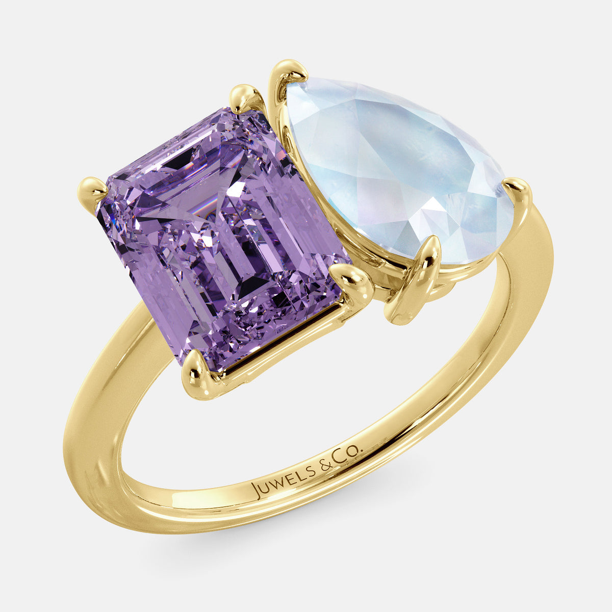 A toi et moi ring with an emerald-cut amethyst and a pear-cut gemstone. The emerald-cut morganite is set on the left of the ring, and the pear-cut gemstone is set on the right. The ring is made of recycled yellow gold and has a simple, elegant design. The pear-cut gemstone can be customized. **Here are some additional details about the image:** * The emerald-cut amethyst is a birthstone for February. * The pear-cut gemstone can be customized to any stone of your choice.