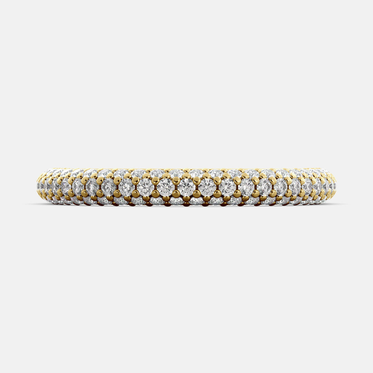 A close-up of a 3-row lab-grown diamond wedding band in 14K yellow gold. The band is set with round brilliant diamonds that sparkle and shine. The band is a beautiful and timeless choice for a wedding band.