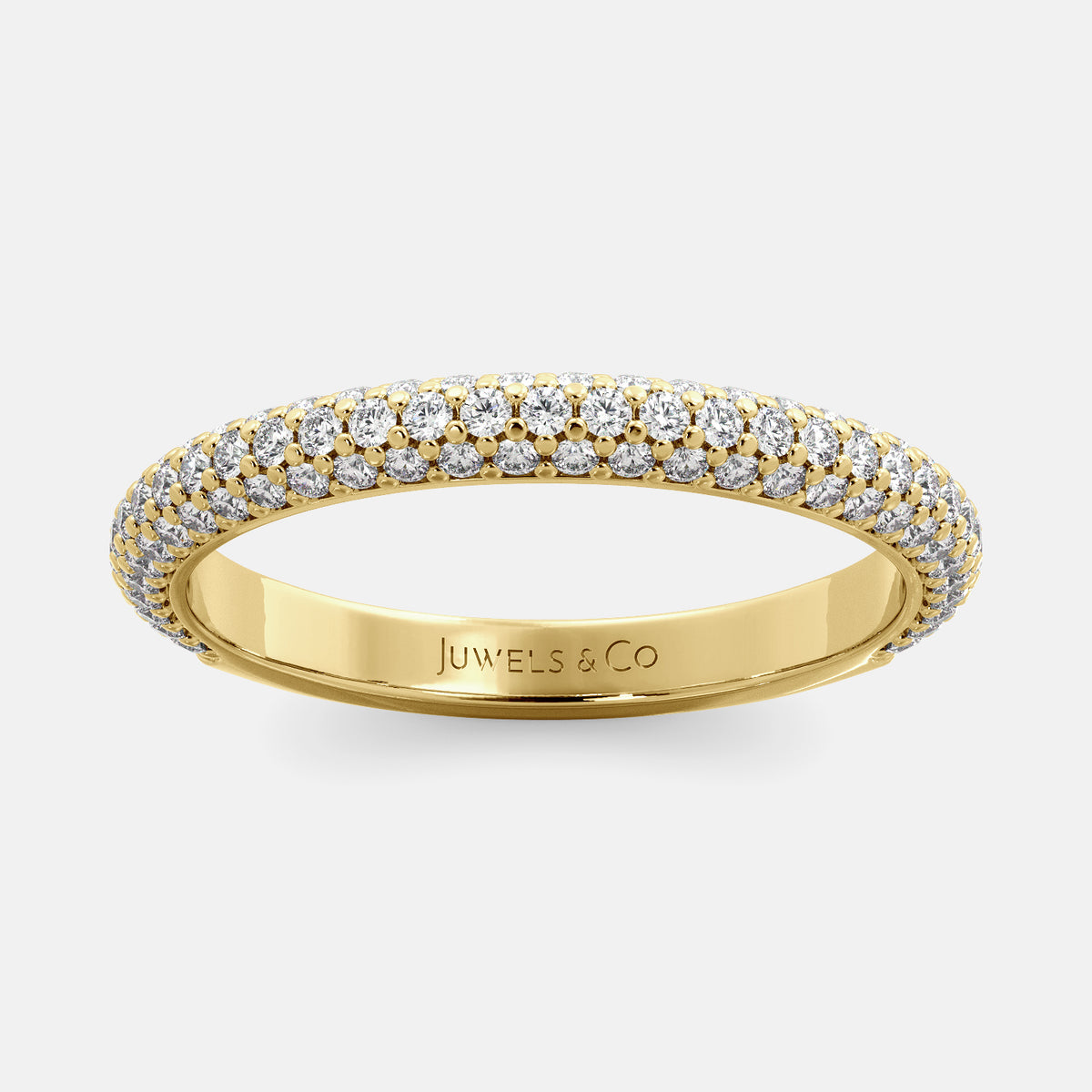 A close-up of a 3-row lab-grown diamond wedding band in 14K yellow gold. The band is set with round brilliant diamonds that sparkle and shine. The band is a beautiful and timeless choice for a wedding band.