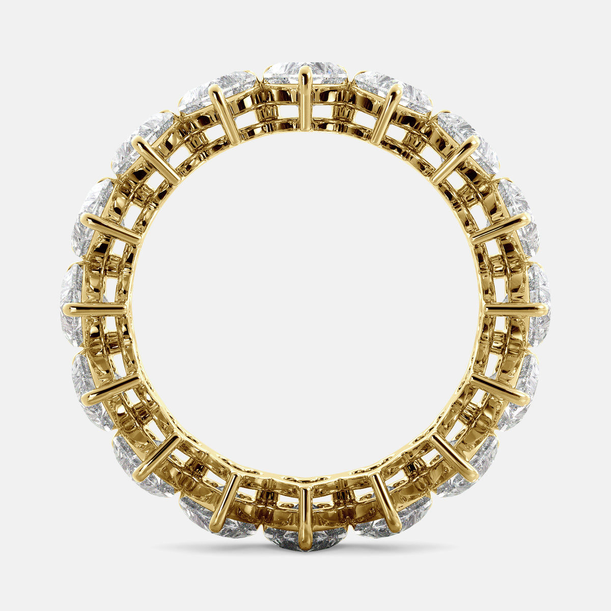 A close-up of a heart-shaped lab-grown diamond eternity wedding band in 14K yellow gold. The band is set with heart shape brilliant diamonds that sparkle and shine. The band is a beautiful and unique choice for a wedding band.