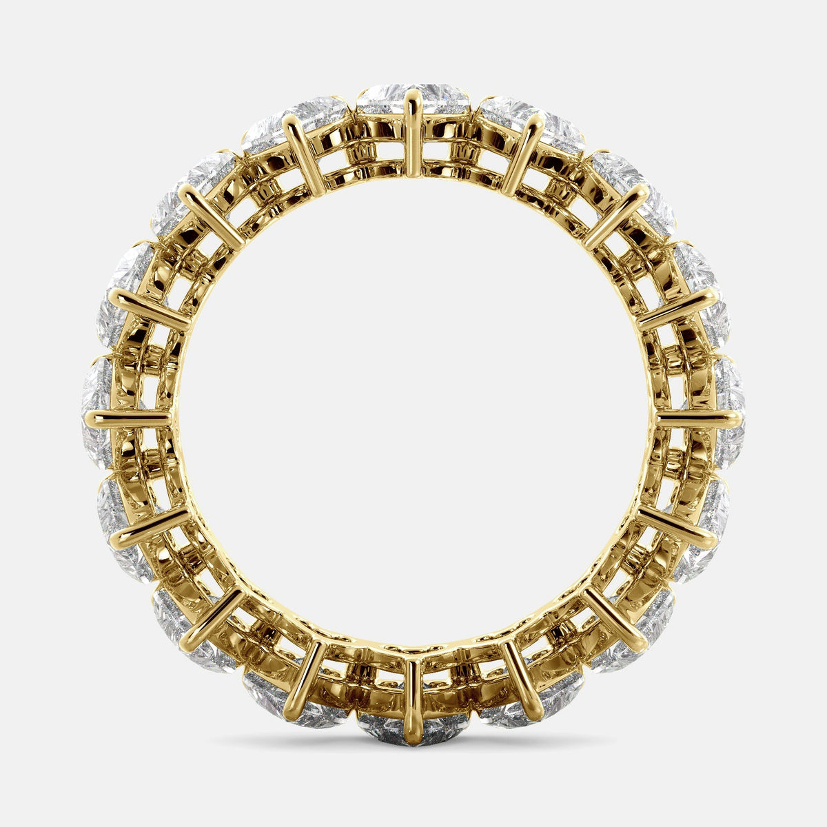 A close-up of a heart-shaped lab-grown diamond eternity wedding band in 14K yellow gold. The band is set with heart shape brilliant diamonds that sparkle and shine. The band is a beautiful and unique choice for a wedding band.