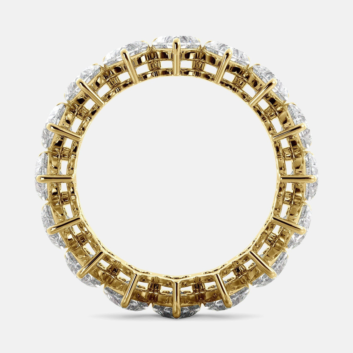 A close-up of a heart-shaped lab-grown diamond eternity wedding band in 14K yellow gold. The band is set with heart shape brilliant diamonds that sparkle and shine. The band is a beautiful and unique choice for a wedding band.
